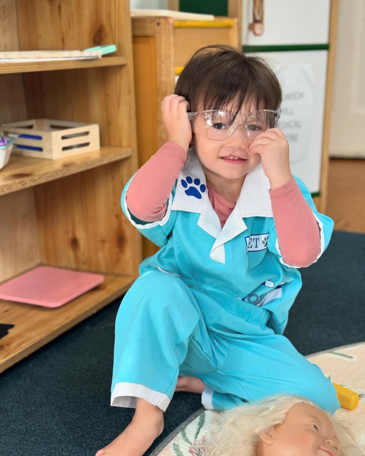 Child in pretend play doctor costume