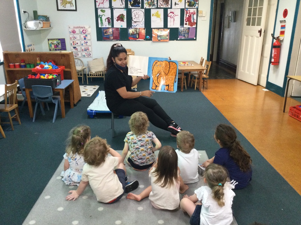 Educator reading with preschool children