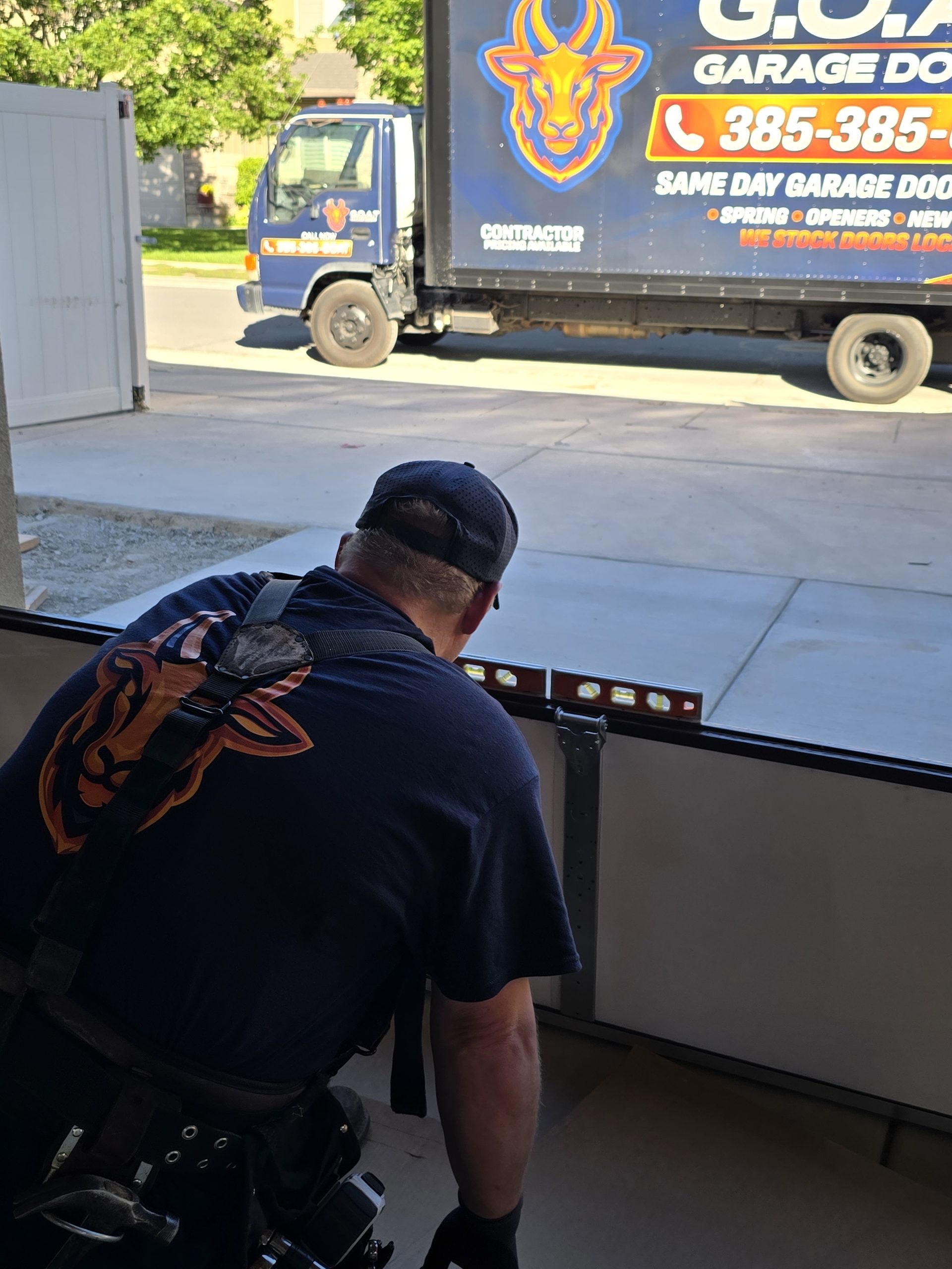 GOAT installers working on a custom garage door