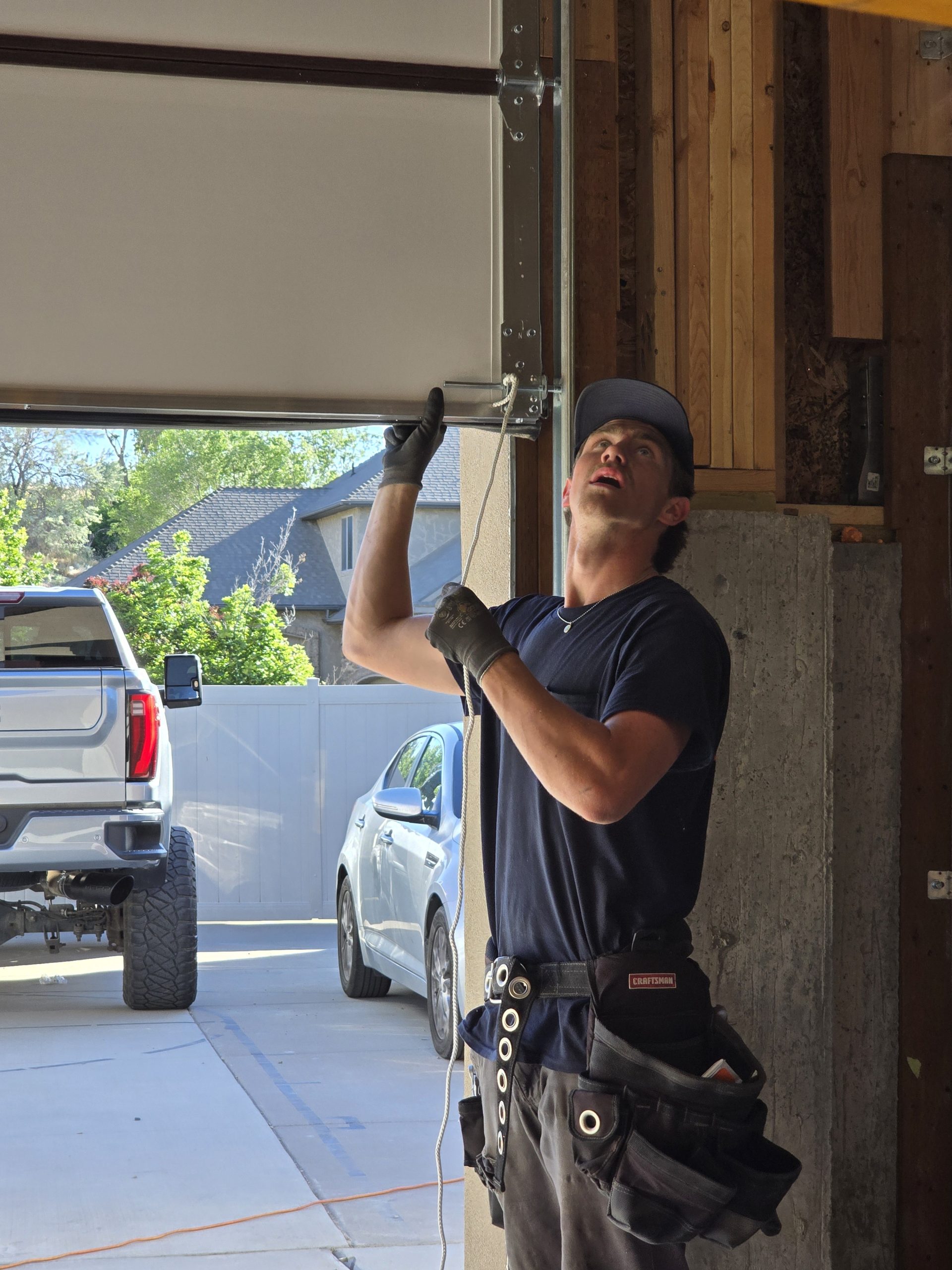GOAT technician inspecting a residential garage door system