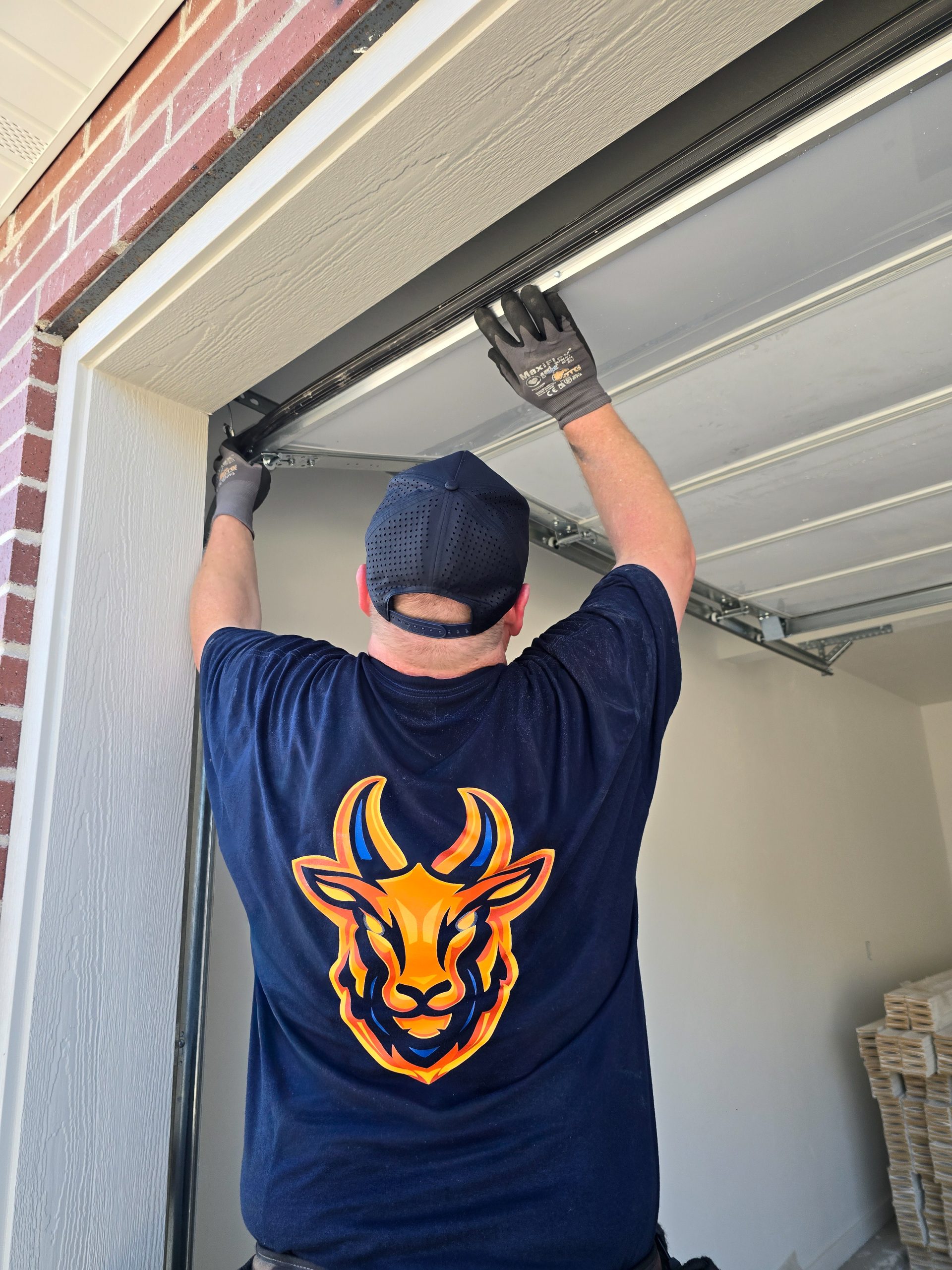 GOAT technician performing a garage door tune-up