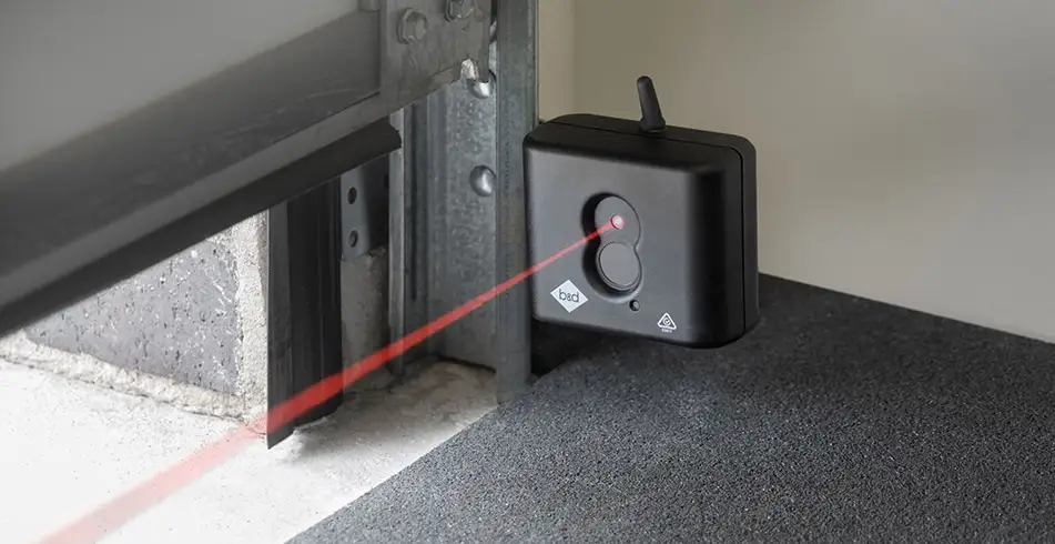 Garage door safety beam sensor with indicator light